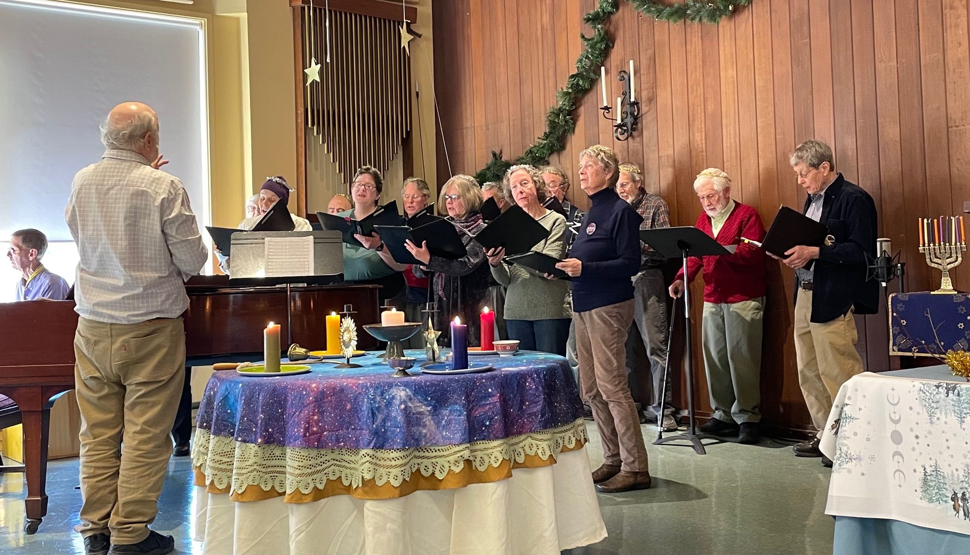 The A2U2 choir singing during a Sunday service, with the music director at the piano