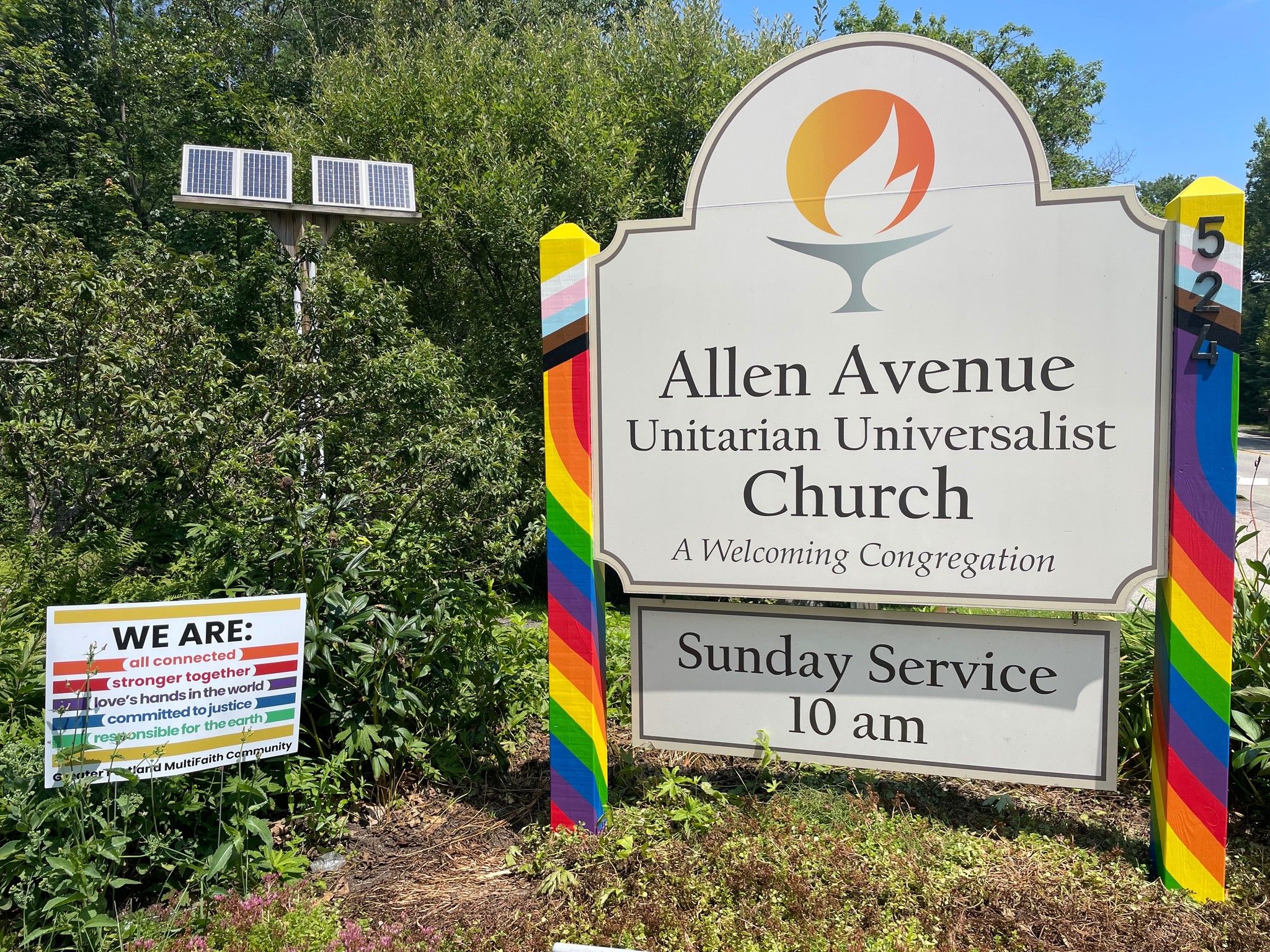 The Allen Avenue UU sign with rainbow-painted posts and a Sunday Service 10 am panel.